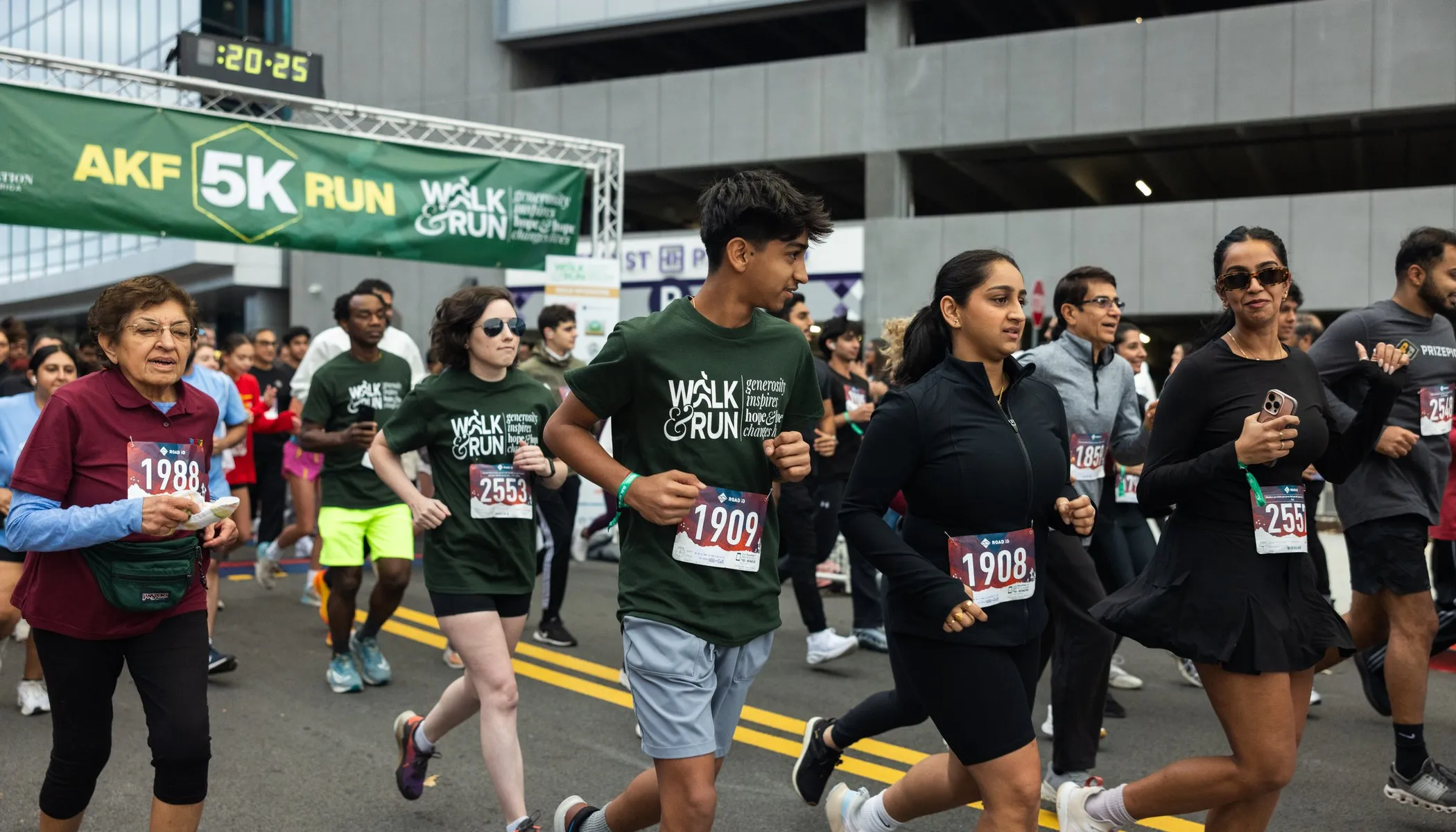 Runners setting off under the AKF 5K Run banner at the start line
